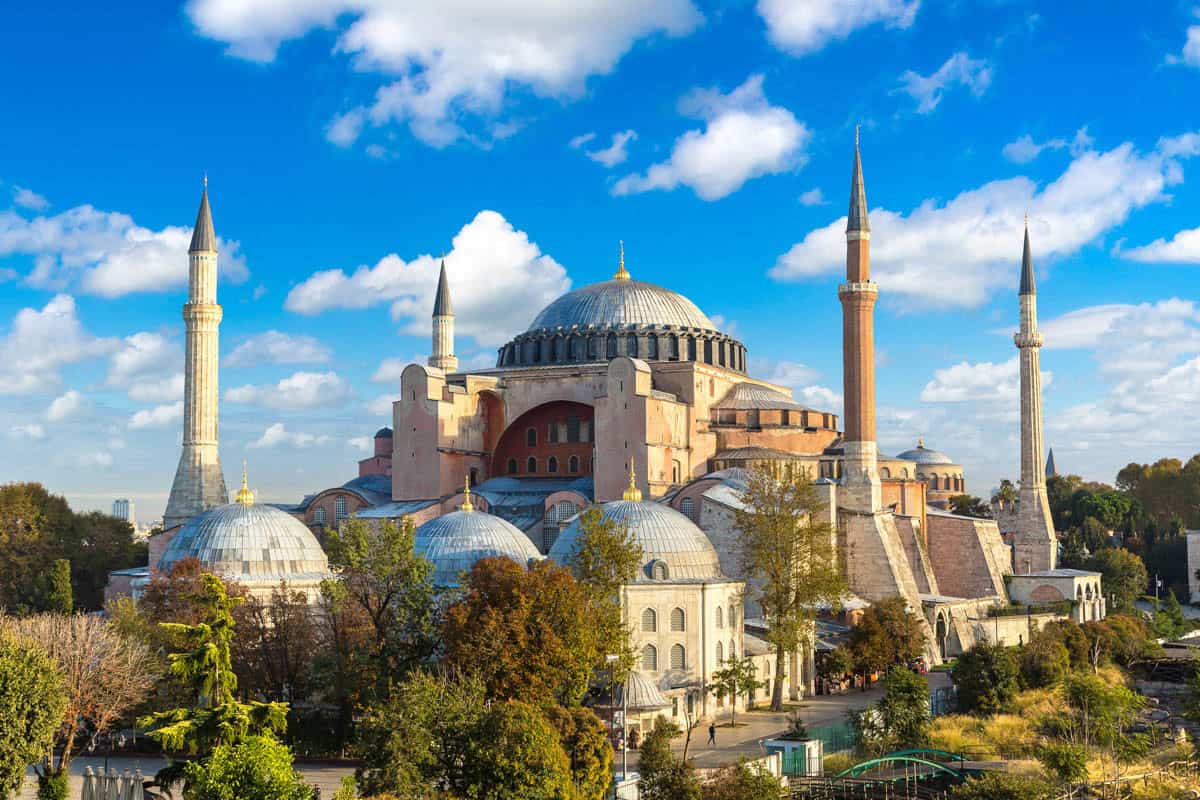 Hagia Sophia's central dome and four minarets rise above surrounding buildings in Istanbul, Turkey.